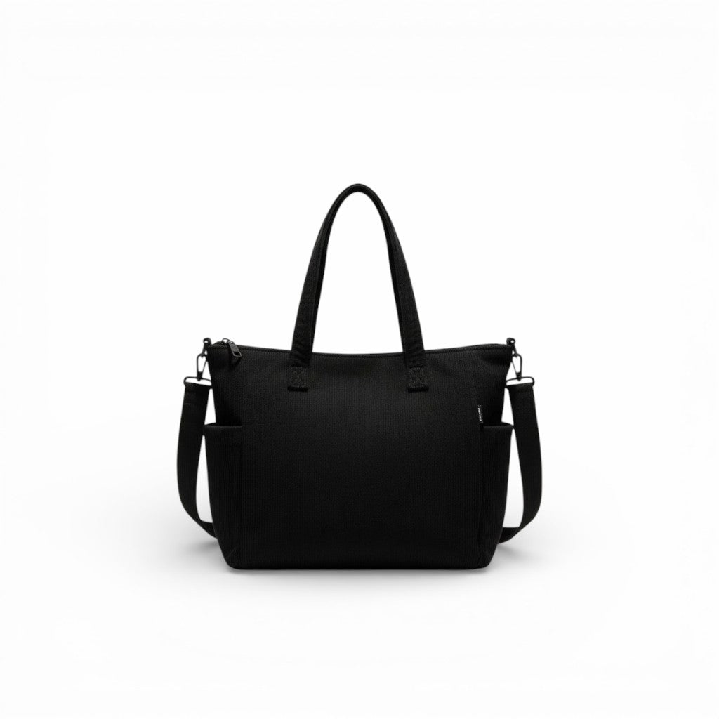 Black handbag with a shoulder strap on a white background