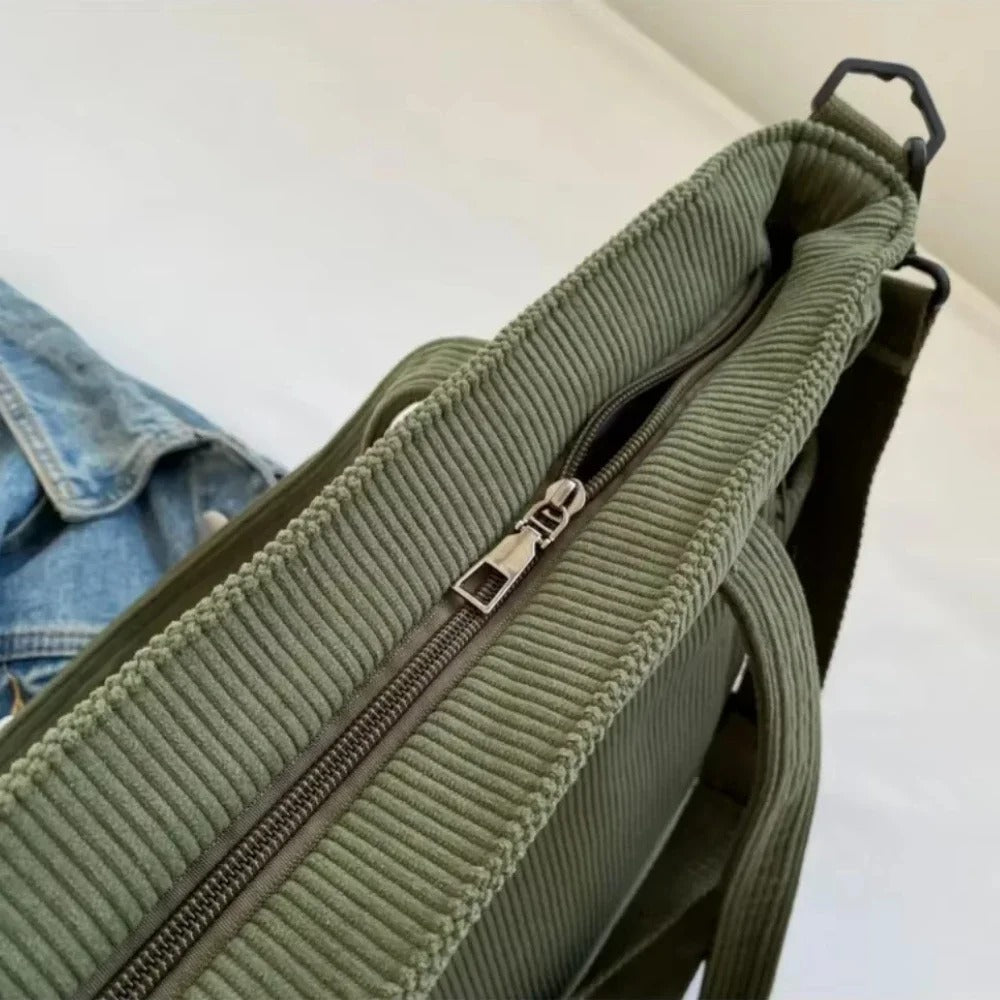 Green tote bag with a zipper on a white background