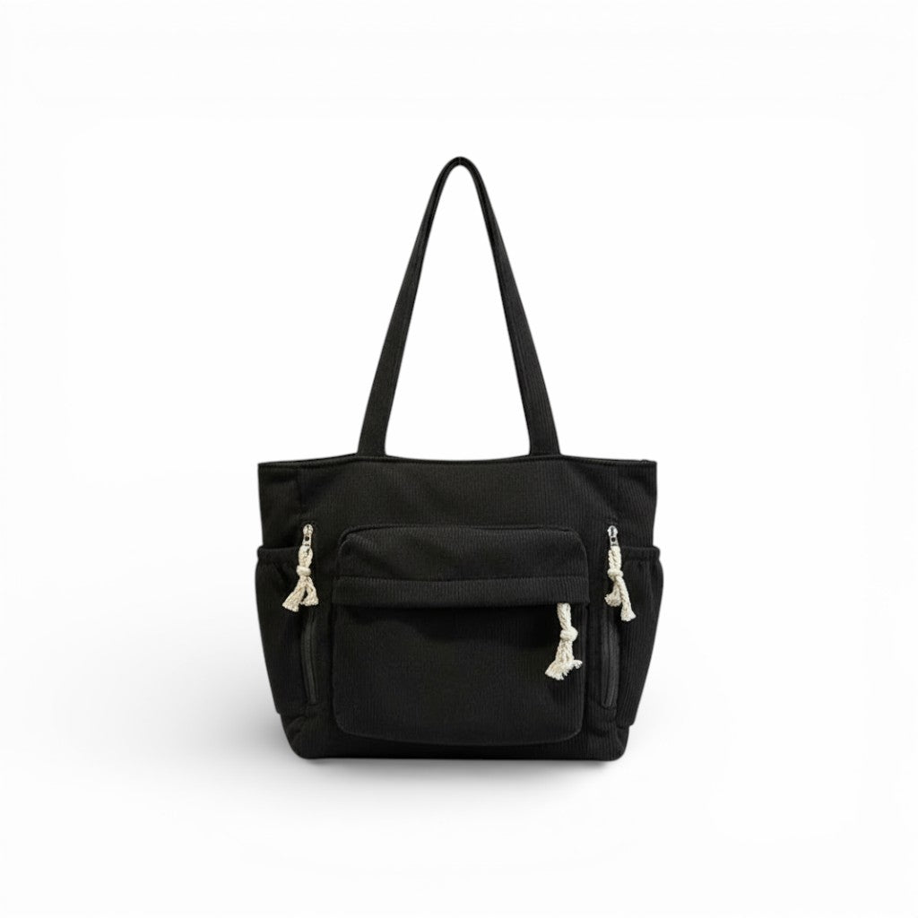 Black tote bag with shoulder straps on a white background