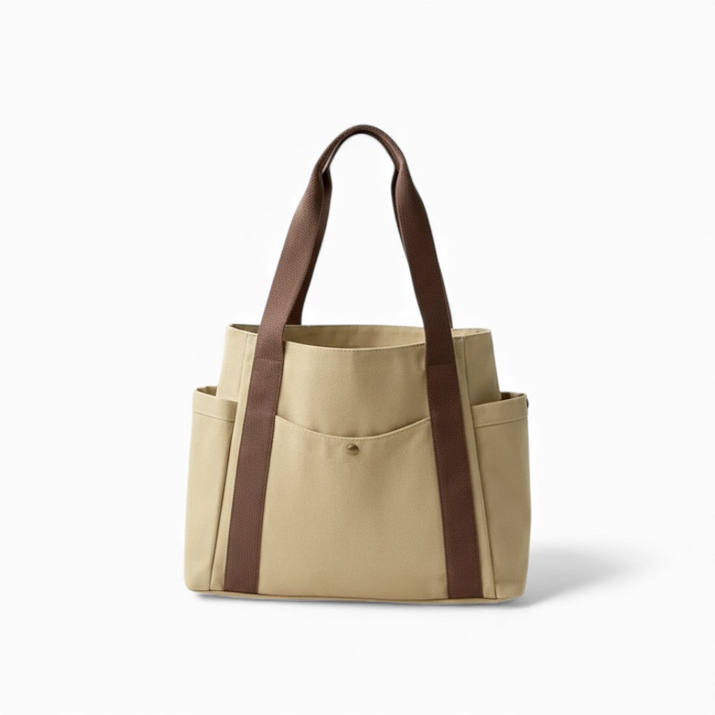 Beige tote bag with brown straps on a white background