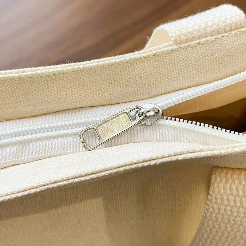 Close-up of a beige fabric bag with a zipper