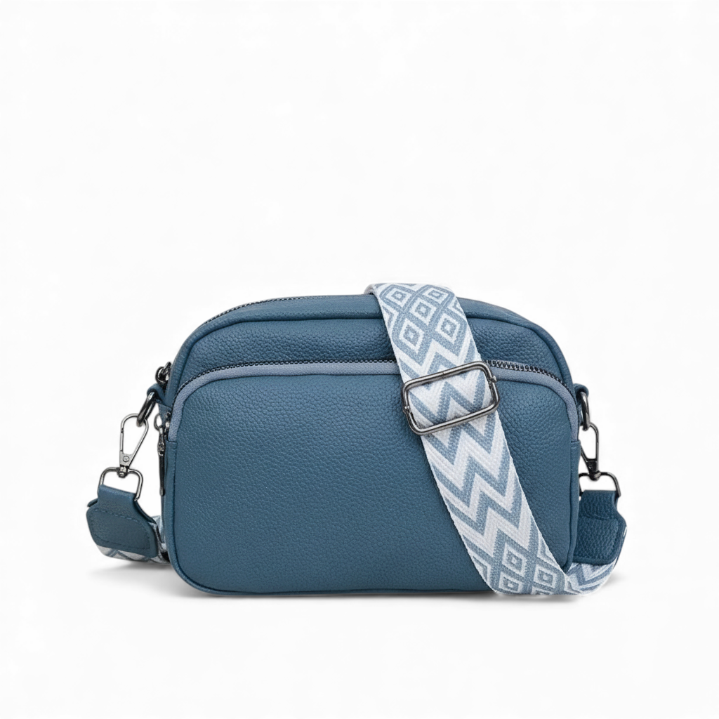 Blue handbag with a patterned strap on a white background