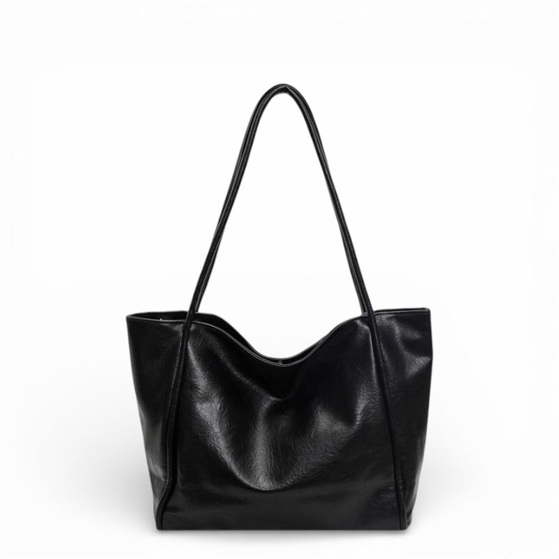 Black leather tote bag on a white background