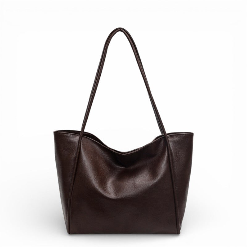 Brown leather tote bag on a white background