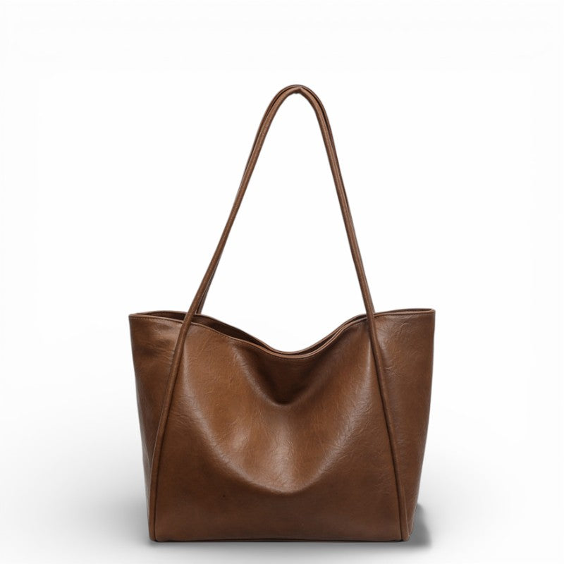 Brown leather tote bag on a white background