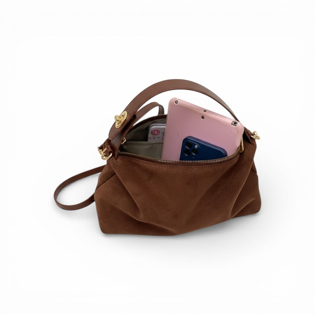 Brown handbag with a phone inside on a white background